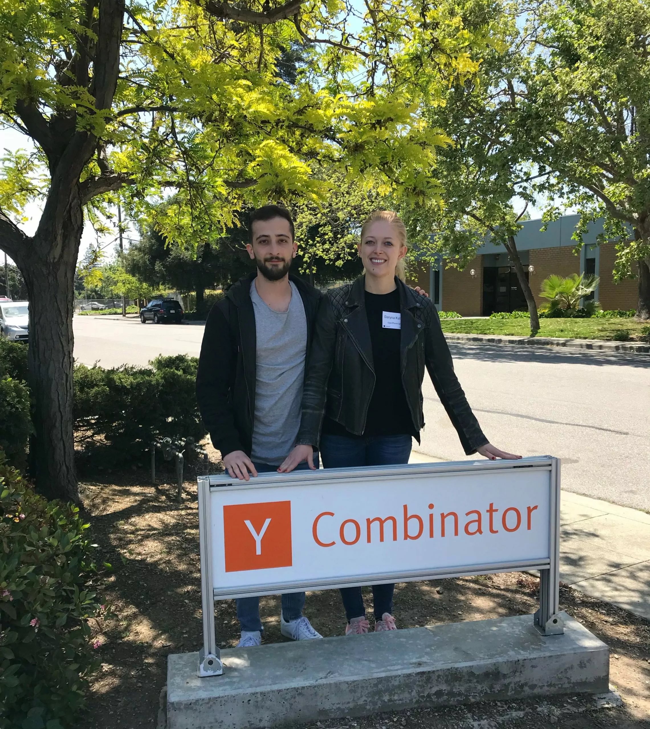Daryna and Mahyar standing in front of Y Combinator sign