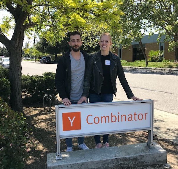 Mahyar Raissi and Daryna Kulya, co-founders of OpenPhone, in front of the Y Combinator sign